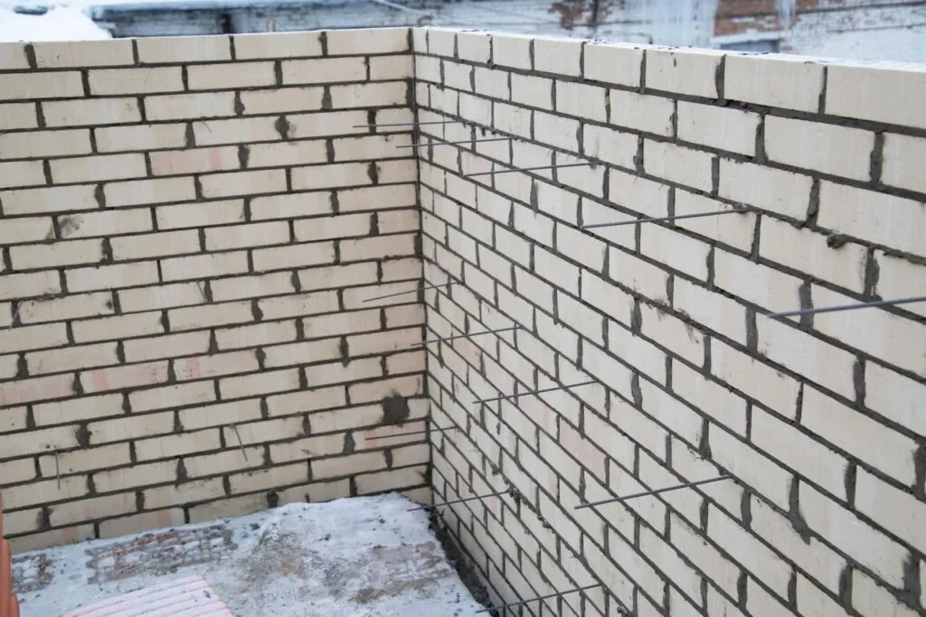 Reinforced concrete block retaining wall